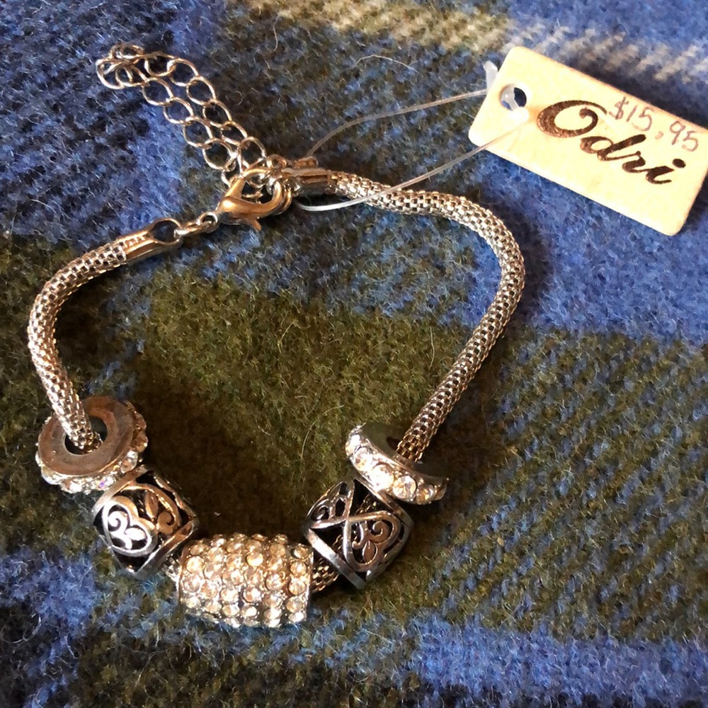 Very pretty charm bracelet by Odri silvertone mesh bracelet with rhinestones